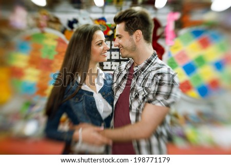 affectionate  young couple visiting an attractions park  - shoot with lens baby