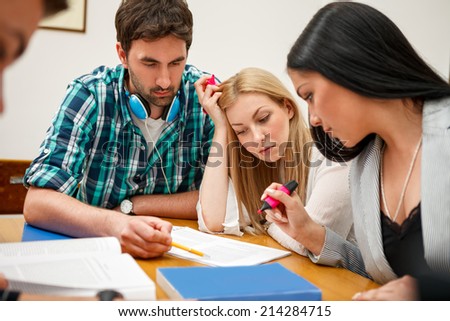 Group of students studying together at the classroom