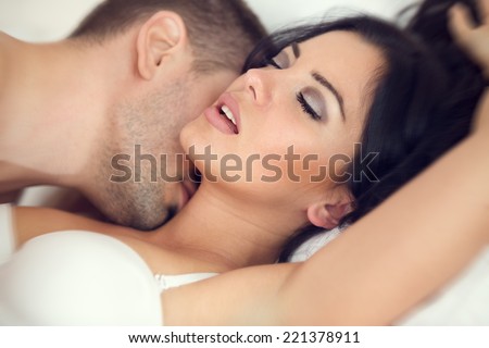 amorous couple making love in bed