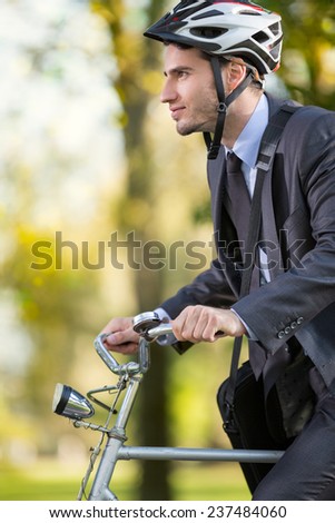 young businessman in suit wearing bike helmet go to work