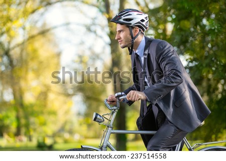 Young business man on a bike hurry to work