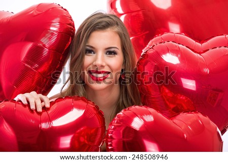 Love woman smiling with red heart shaped balloon