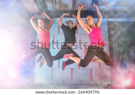 Group of young people jumping during music