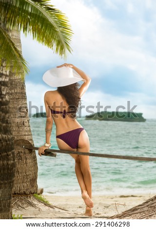 Woman enjoying blue sea. Vacation. Back view.