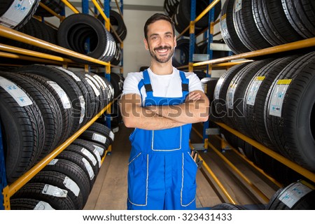 Portrait of  male auto mechanic in tire store