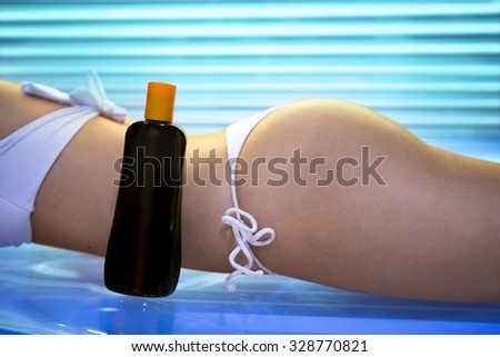 Sexy female body on tanning bed with bronzing oil - Beauty, healthcare.