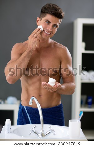 Morning routine in bathroom, young man preparing face for shaving