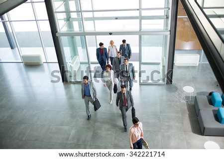 Group of professional business people walking on the way in building