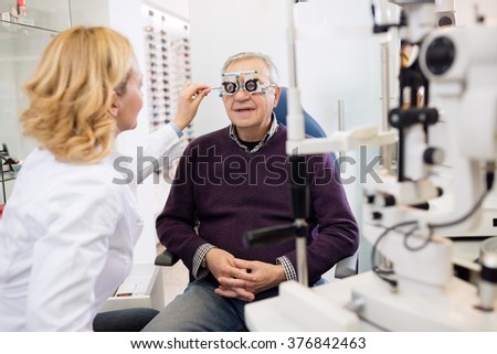 Optic specialists views eyesight to patient in eye clinic