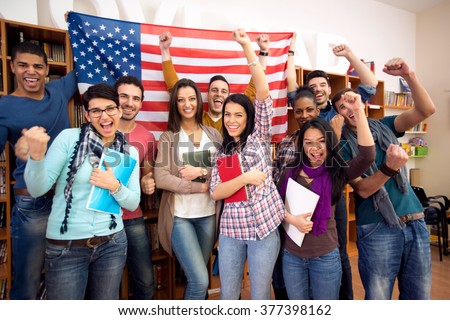 Smiling  American students presenting their country with flags