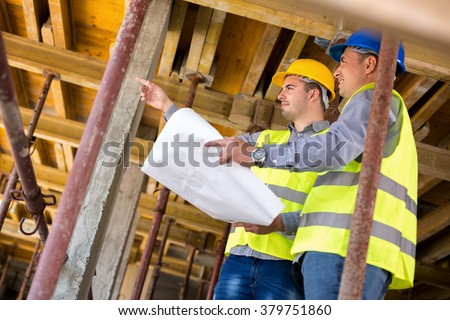 Handsome  architect with supervisor of the construction site show place of build up on construction site