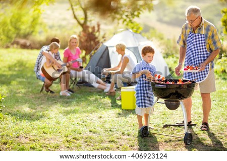 happy family on camping making barbecue