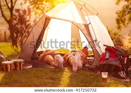Couple sleeping in tent at early morning sun