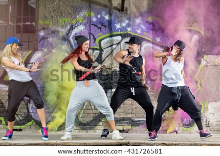 Young modern dancing group practice body jam in front colorful wall