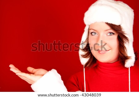 cute christmas girl presenting product on red background
