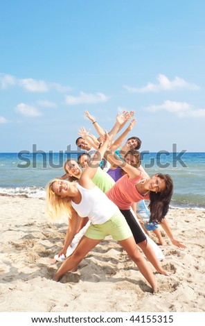 group of young people having fun on the beach