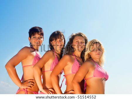a group of happy young girls posing in sexy bikinis