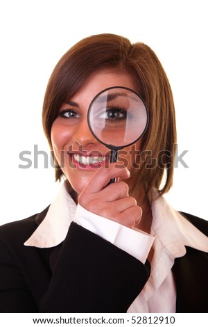 smiling businesswoman looking through a magnifying glass