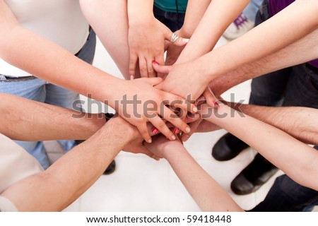 close up of many hands in circle - students connection