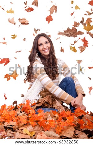 attractive autumn woman in a colorful pile of leaves