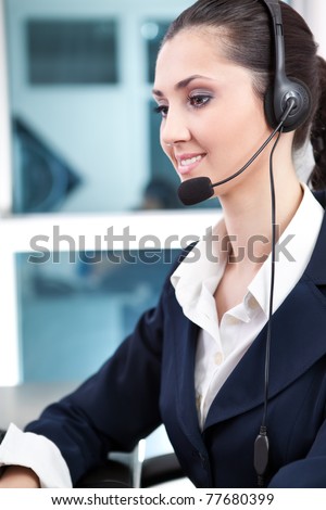 beautiful customer representative with headset smiling during a telephone conversation