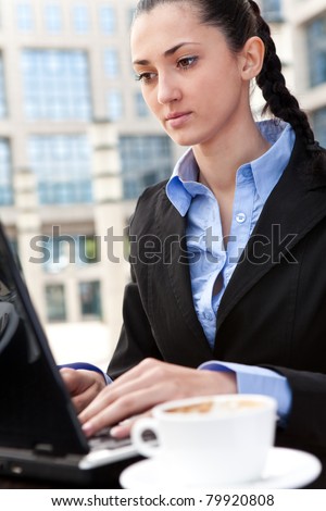 business woman working on lap top computer and drinking coffee internet cafe