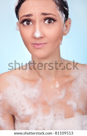 cute young woman with foam on nose , funny bath