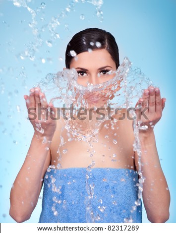young female wash her face with water