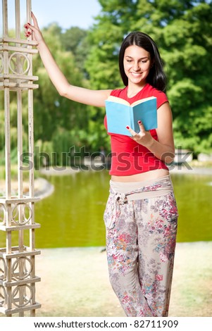 beauty student girl reading book in her garden