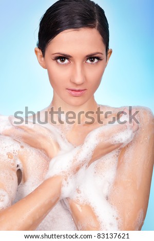 naked woman in soap foam , washing her body