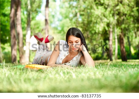 student learning outdoor, student girl relaxing and reading book in park, school education