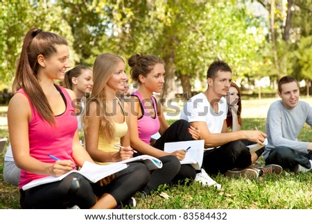 group of students with books learning outdoor