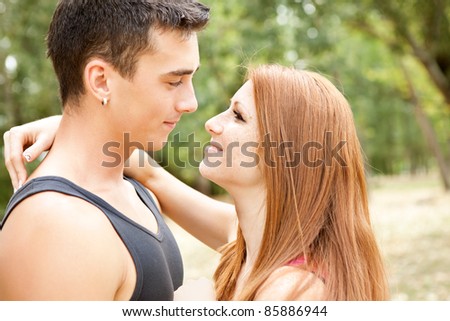 young lovers in embrace, looking each other