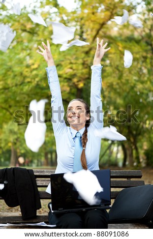 happiness businesswoman throwing paper in the air, outdoor