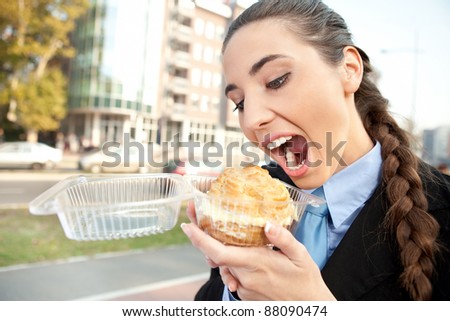 hungry  businesswoman eating donut princess, open mouth