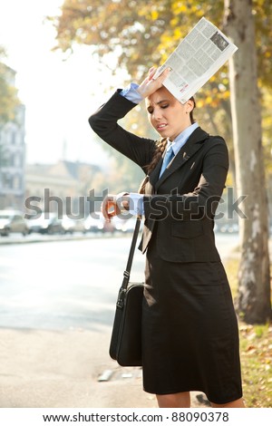 business woman is late for work or a meeting, looking in watch