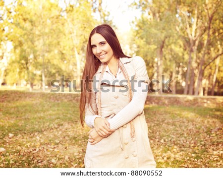 young woman posing in autumn park