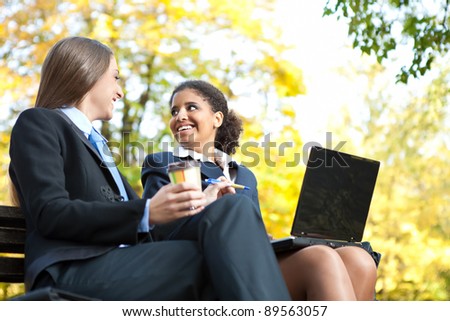 young smiling businesswomen working together, outdoor