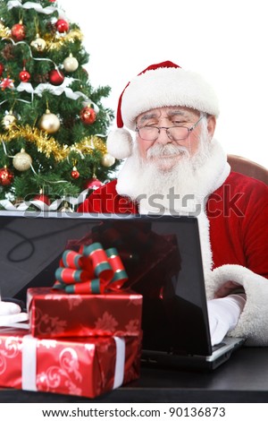 Santa Claus reading e-mail and communicate with children all over the world, isolated on white background