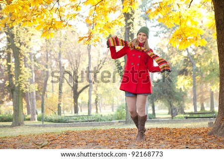 happy , young funny girl enjoying in  golden autumn park