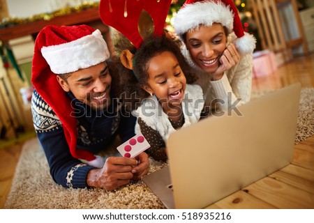 afro African family realize Christmas shopping online from warm living room at home