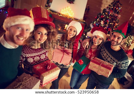 Young happy people on Christmas with gifts