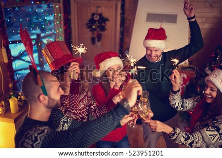 Cheerful friends toasting at New Year\'s midnight