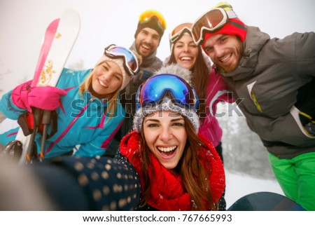 smiling friends making selfie and having fun on winter hodays