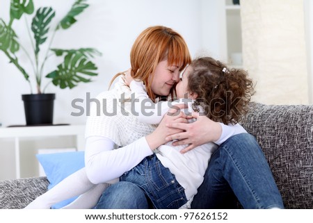 Mother and daughter kissing with noses