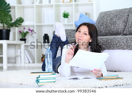 Young female  student thinking and smiling with book