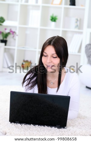 young girl looking at laptop computer, indoor