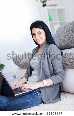 Portrait of a smiling young lady with laptop