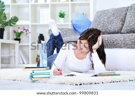 Young student girl with books on floor studying