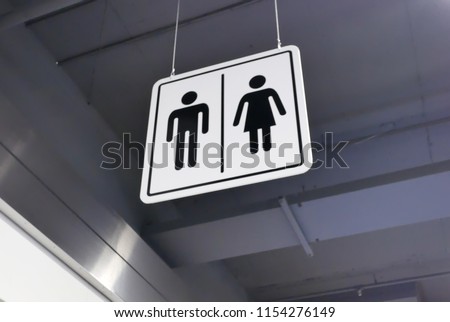 Close up of man and woman washroom logo on roof
